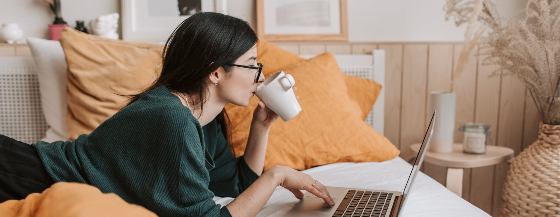 a woman looking onto her laptop