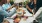 a group of people having a meal around an outdoor table